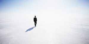 Businessman walking along empty landscape